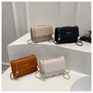 Fashionable chain crossbody bag in beige, black, brown, and white with wavy flap edges