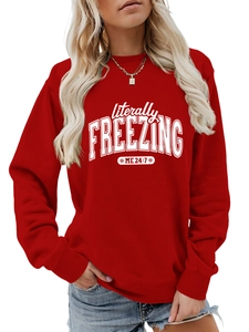 Detail of red crewneck sweatshirt with white 'literally FREEZING' print and snowflakes