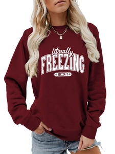 Detail of burgundy sweatshirt featuring white Literally Freezing 24/7 slogan print