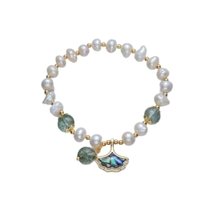Baroque pearl bracelet with green phantom stones and golden ginkgo leaf charm detail