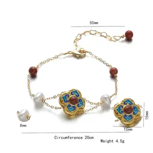 Floral freshwater pearl bracelet with blue enamel flower and red agate beads