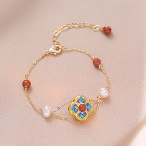 Elegant gold chain bracelet with freshwater pearls, red agate beads and floral charm
