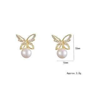 Elegant gold butterfly stud earrings with sparkling crystals and round white pearls