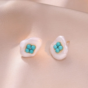 Vintage water drop freshwater pearl earrings with turquoise accents on satin background