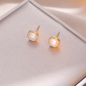 French retro pearl stud earrings with gold twisted rope borders on jewelry box