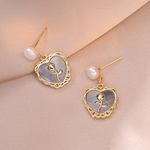 Elegant heart-shaped shell earrings with gold rose detail and white pearl drops