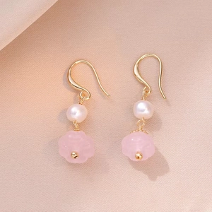 Elegant drop earrings featuring natural freshwater pearls and pink crystal flower charms