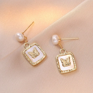 Elegant gold butterfly earrings with natural freshwater pearls and mother of pearl base