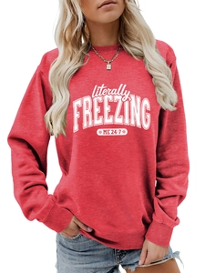 Detail of red crewneck sweatshirt featuring white Literally Freezing 24:7 graphic print