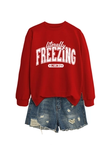 Detail of red sweatshirt with 'literally freezing' print and distressed denim shorts