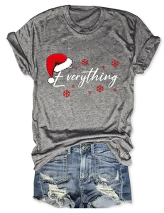 Flat lay of gray Christmas t-shirt with 'Everything' print and distressed denim shorts