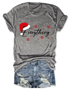 Flat lay of gray Christmas T-shirt with Everything print and ripped denim shorts