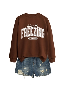Flat lay of brown literally freezing sweatshirt paired with ripped denim shorts