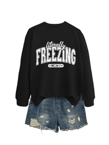 Detail of black cotton sweatshirt featuring white literally freezing me 24:7 graphic art