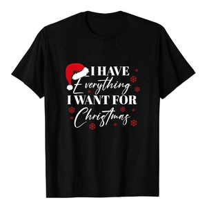 Close-up of black cotton T-shirt with white Christmas typography and festive graphic