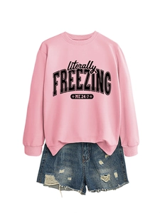 Detail of pink sweatshirt with literally FREEZING ME 24:7 print and frayed denim shorts