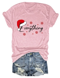Flat lay of pink Christmas T-shirt with 'Everything' text and ripped denim shorts