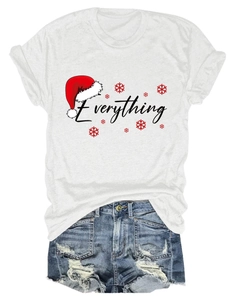 Flat lay of white Christmas t-shirt with Everything text and denim shorts