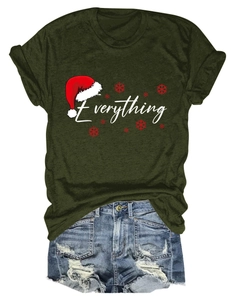 Flat lay of green Christmas T-shirt with Everything print and distressed denim shorts