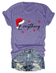 Flat lay of purple Everything t-shirt with Christmas motif and frayed denim shorts