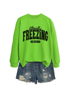 Detail of neon green crewneck sweatshirt with literally freezing print and denim shorts