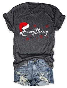 Flat lay detail of dark gray Everything Christmas t-shirt and ripped denim shorts