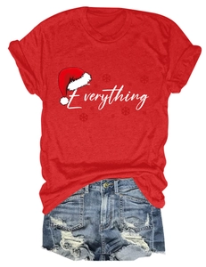 Flat lay of red Christmas T-shirt with 'Everything' print and ripped denim shorts
