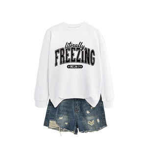 White crewneck sweatshirt with 'literally freezing' text and ripped denim shorts set