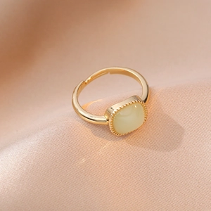 Adjustable gold ring featuring a cream square cabochon gem and beaded edge detail