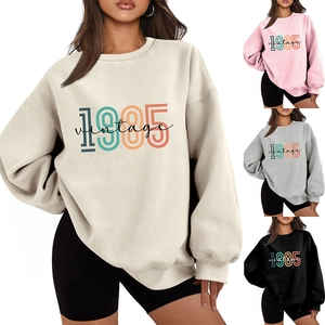 Close-up of vintage 1985 printed sweatshirts showing loose fit design in multiple colors