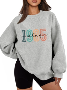 Detail of 1985 vintage print on oversized grey cotton sweatshirt for women