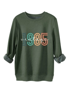 Detail of dark green 1985 vintage sweatshirt with fleece lining and rolled cuffs