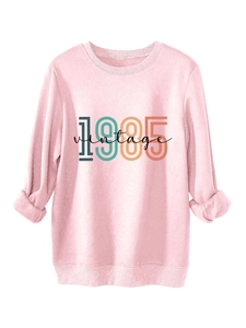 Detail of pink vintage 1985 sweatshirt showing the rolled cuffs and soft fabric texture
