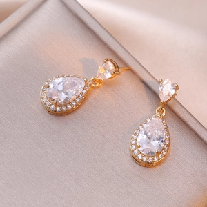 Elegant gold-tone teardrop halo earrings featuring sparkling clear cubic zirconia stones
