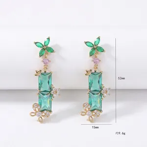 Elegant emerald green dangle earrings with butterfly gold accents and sparkling zircons