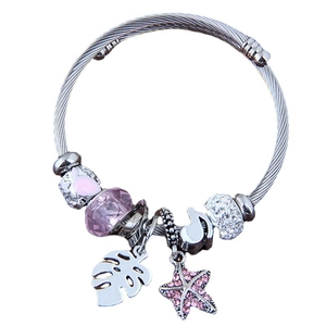 Silver twisted cable cuff bracelet featuring pink heart, starfish, and leaf charms