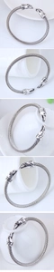 Detailed close-up showing intricate eagle head carvings on vintage silver twisted cuff bracelet