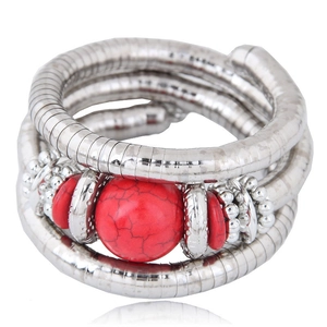 Detail of bohemian multilayer coil bracelet with red turquoise beads on white background