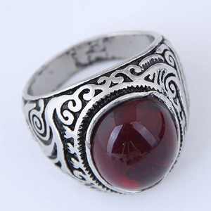 Retro silver ring with ornate floral engraving and a large round red gemstone center