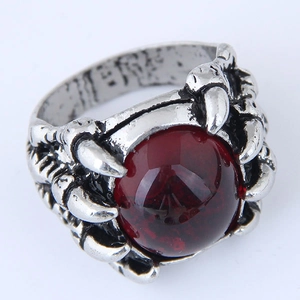 Retro mens ring with dark red gemstone held by gothic silver dragon claw prongs