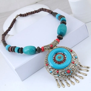 Ethnic style necklace with turquoise accents, vintage bronze pendants and metal tassels