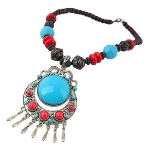 Bohemian ethnic necklace with turquoise pendant and bronze tassels on beaded cord