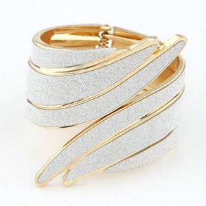 Elegant gold and silver winged punk bracelet featuring textured metal leaf-like design
