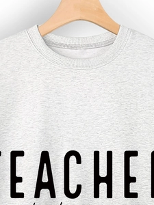Detail eines hellgrauen Teacher-Sweatshirts mit geripptem Rundhalsausschnitt und Print