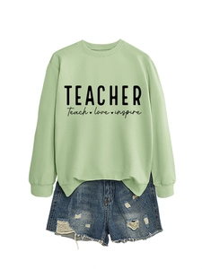 Detailansicht von salbeigrünem Sweatshirt und zerrissenen Jeans-Shorts mit Lehrer-Aufdruck