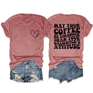 Detail of pink t-shirt with Mom graphic and quote paired with distressed denim shorts
