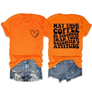 Detail view of orange t-shirt with slogan and denim shorts casual summer outfit set