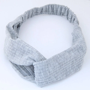 Chic grey ribbed knit headband featuring a twist knot design and elastic back strap