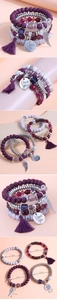 Detail view of purple beaded multi-layer bracelet with feather charm and tassel accents