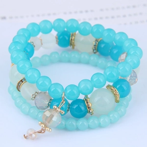 Close-up of bohemian blue cat eye beaded bracelets with crystal wing charm and tassels